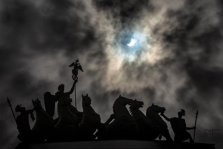 Триумфальная колесница на арке Главного Штаба на Дворцовой площади во время солнечного затмения 20 марта 2015 в Санкт-Петербурге | Total Solar Eclipse of March 20th, 2015 (partial phase) photographed behind a dramatic cloudy sky and a triumphal car on top of General Staff Building at Palace Square in Saint-Petersburg, Russia